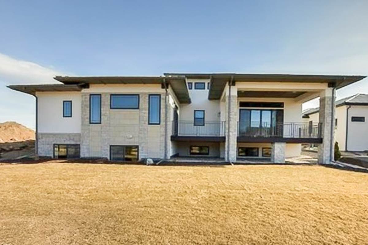Modern house plan exterior with flat roof, multi-story design, prominent window arrangements, and covered balconies.