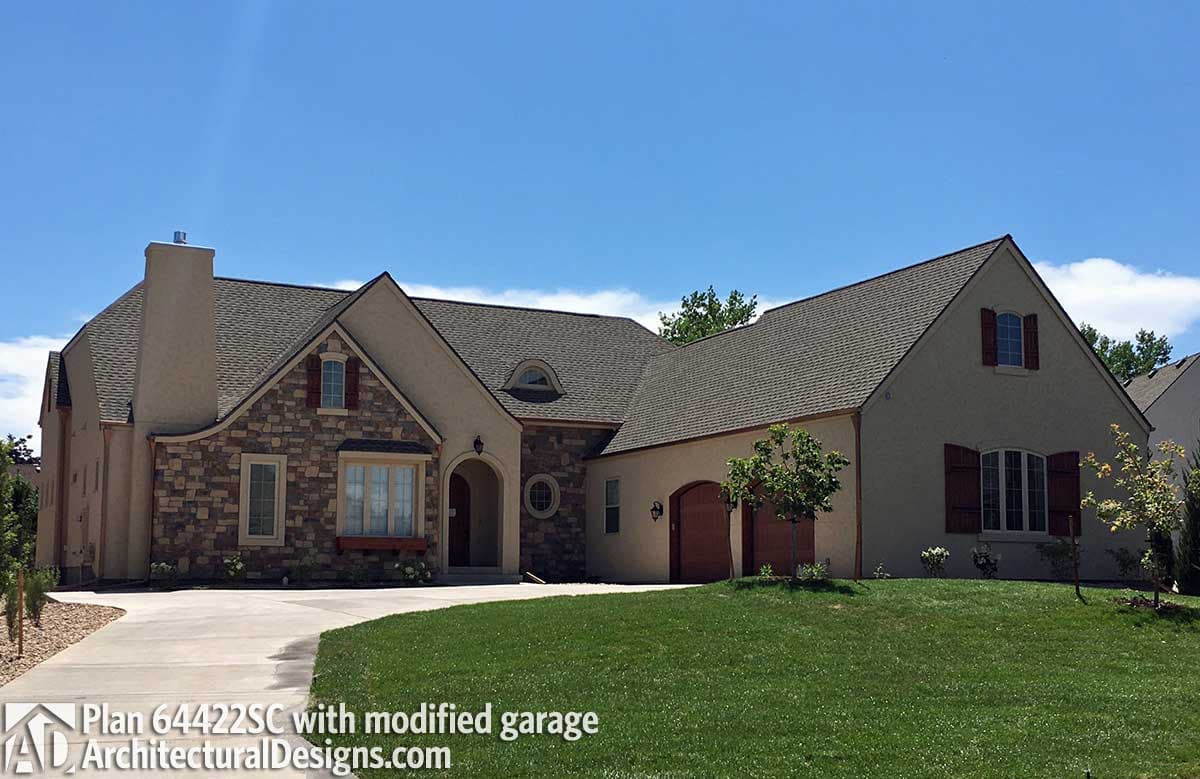 House plan exterior shows a two-story home with stone accents, arched entry, multiple gables, and a side-entry garage.