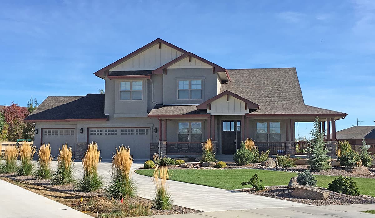 House plan exterior: Two-story Modern Farmhouse with a three-car garage, covered front porch with stone columns, and multiple gables.