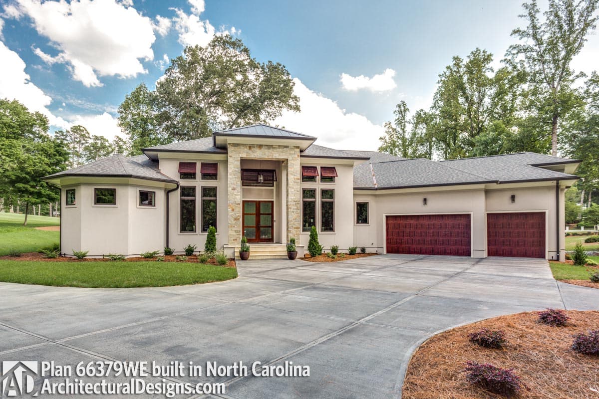 Modern single-story house plan exterior with a stone facade entry, multiple gables, and a three-car garage.