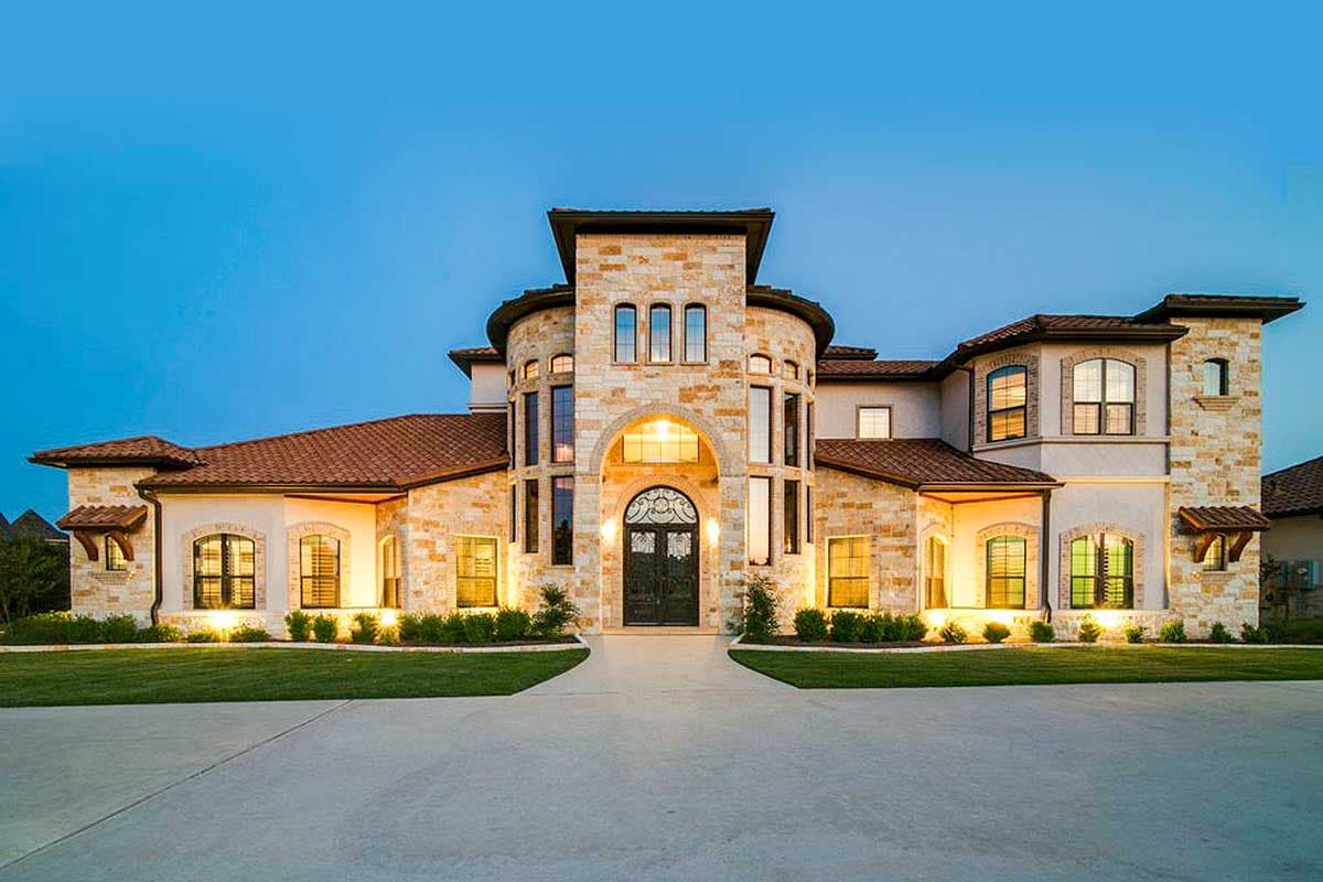 House plan exterior: Mediterranean style, two stories, rounded turret with arched windows, tile roof, and stone accents.