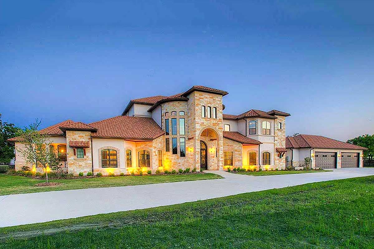 House plan exterior. Two-story Mediterranean-style home with arched entry, multi-gabled roof, stone facade, and attached garage.