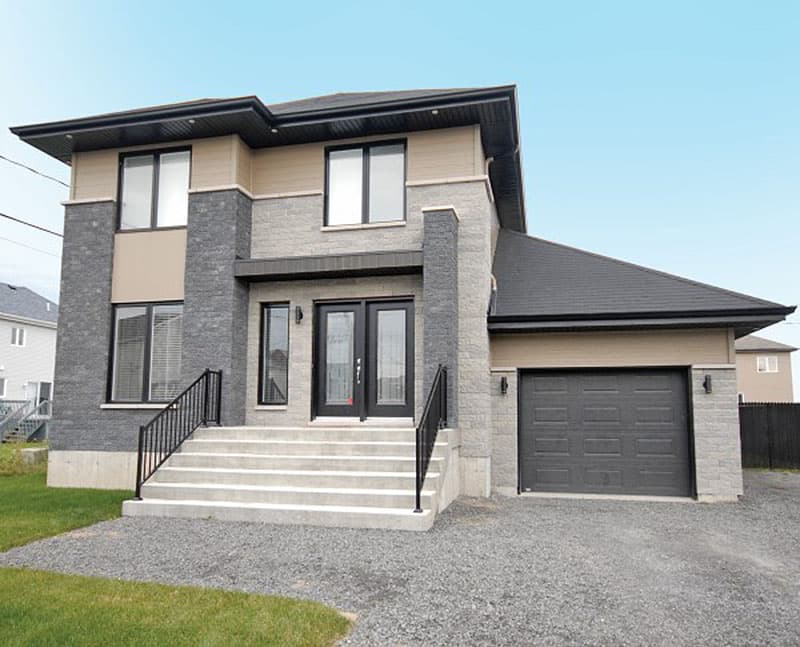 House plan exterior: Two-story modern home with stone and beige siding, double front doors, and attached garage.
