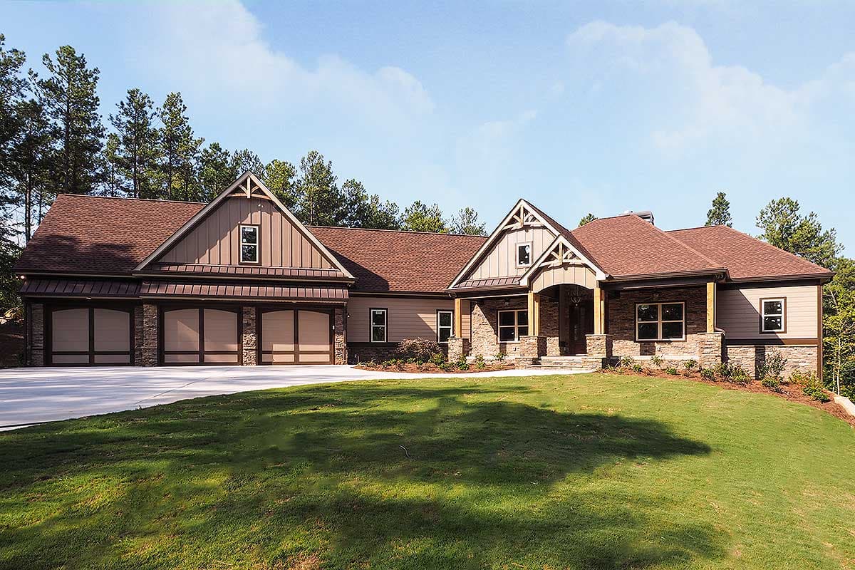 House plan exterior: Modern Farmhouse style, one story, with a three-car garage, stone accents, and covered entryway.