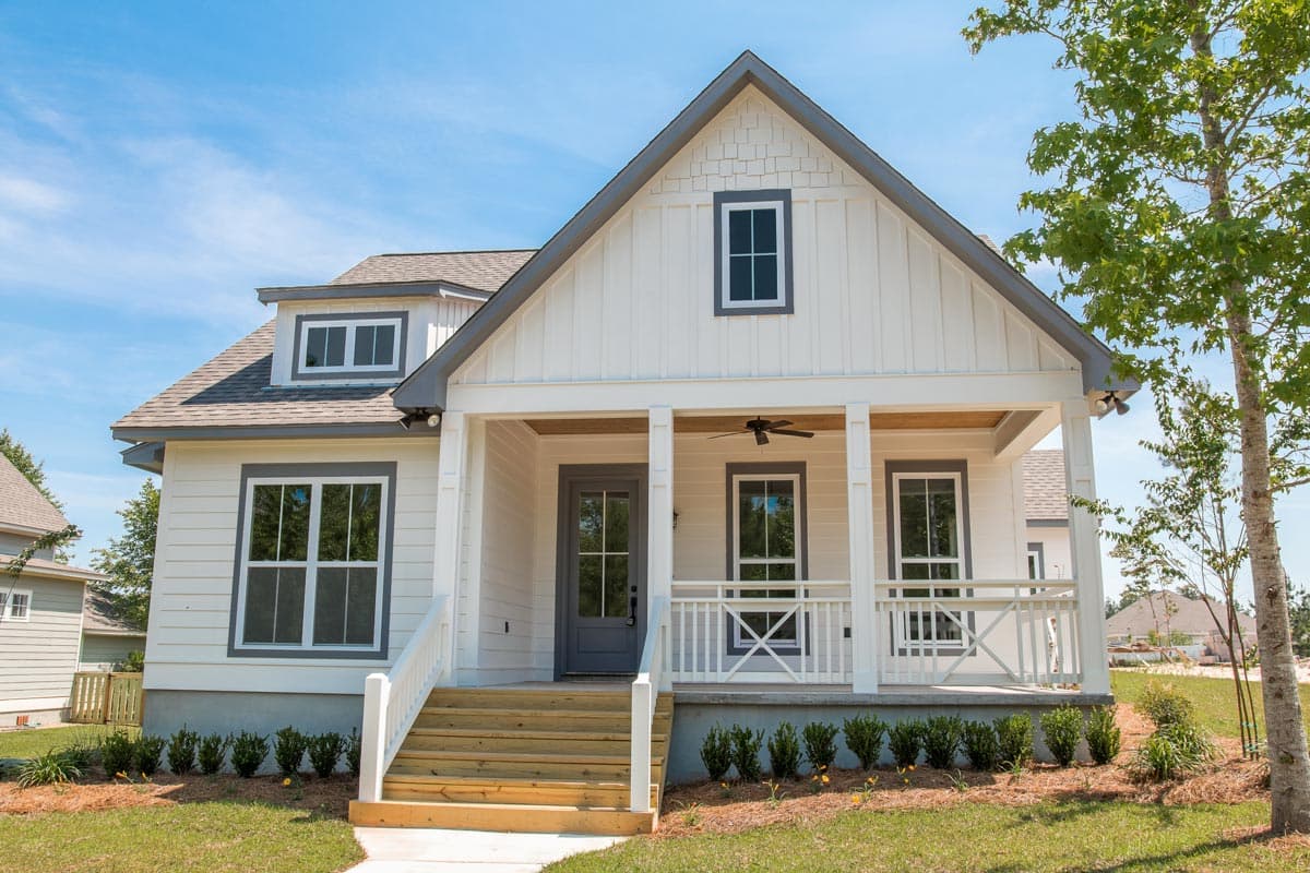 House plan exterior of a two-story Modern Farmhouse with a covered front porch, prominent gable, and dormer window.