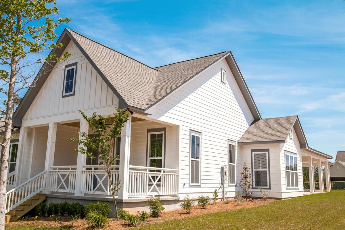 House plan exterior: Modern Farmhouse style, one story, with a covered front porch, board and batten siding, and multiple gables.