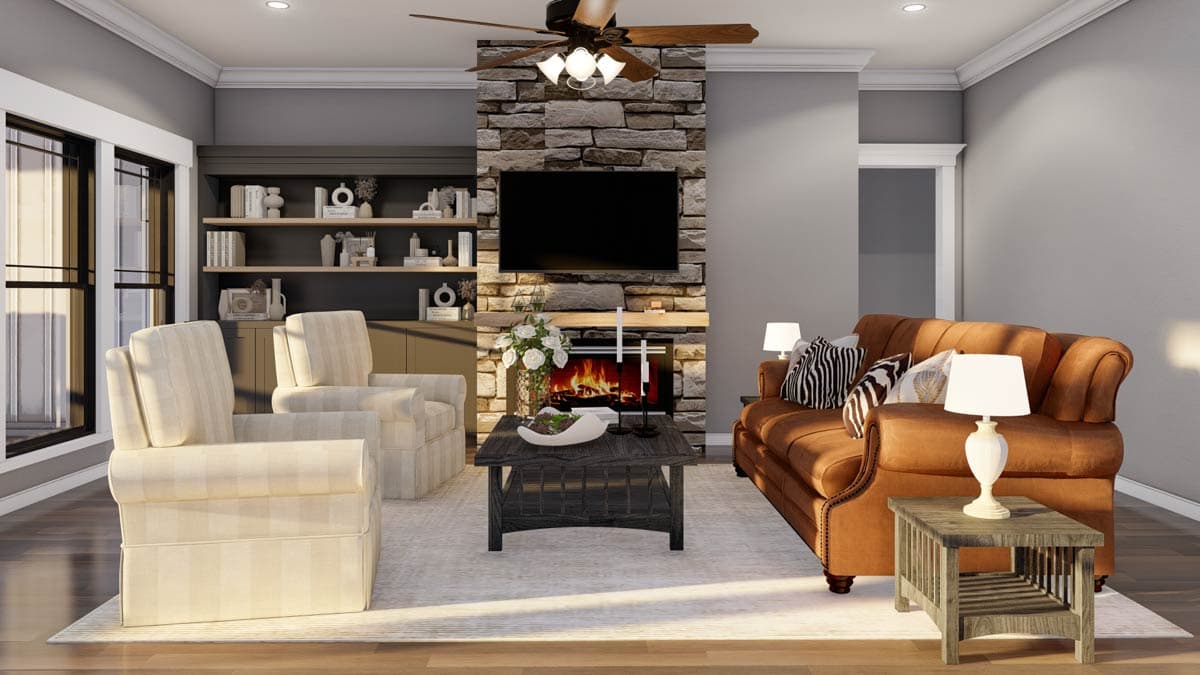 Living room with stone fireplace, built-in shelving, leather sofa, and upholstered chairs.