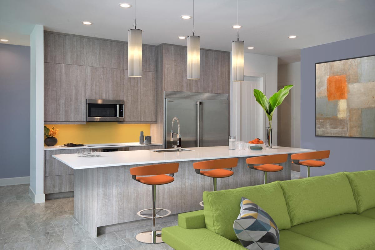 Modern kitchen with gray cabinetry, white island, orange bar stools, and stainless steel appliances. Open to living area.