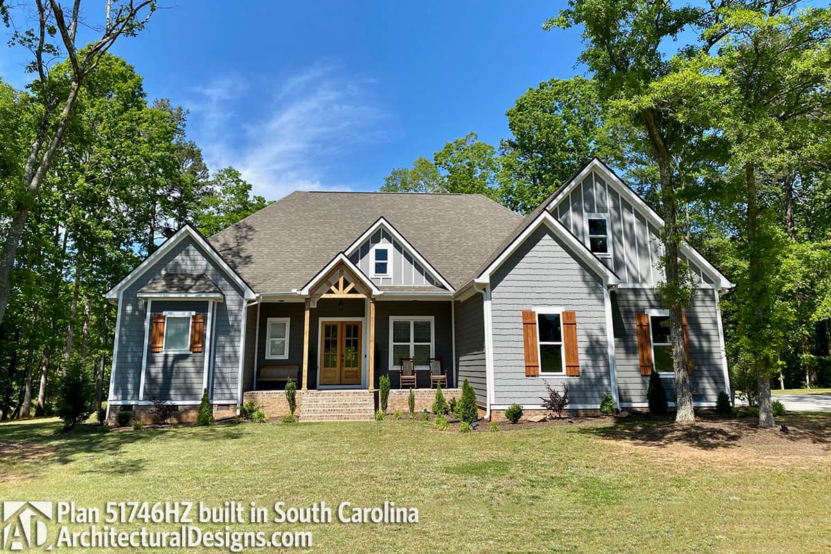 Modern Farmhouse house plan exterior with covered porch, gables, dormers, and shingle siding.