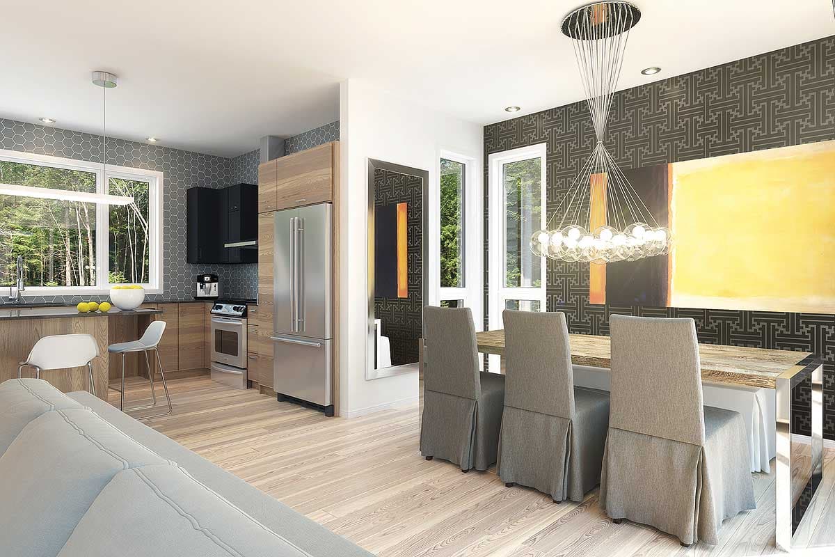 Open concept dining and kitchen area with stainless steel appliances, wood cabinetry, patterned wallpaper, and modern chandelier.