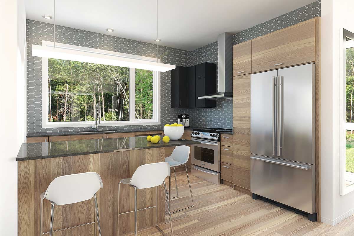Modern kitchen with stainless steel appliances, gray hexagonal backsplash, wood cabinets, and a large window overlooking trees.