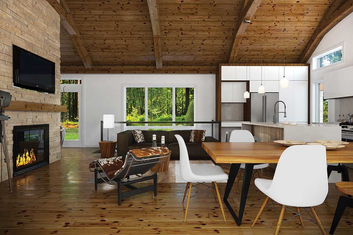 Open concept living space with stone fireplace, vaulted wood beam ceiling, modern kitchen island, and dining area.