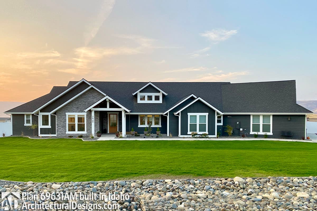 House plan exterior: single-story, modern farmhouse style with stone accents, prominent gables, and covered entry.