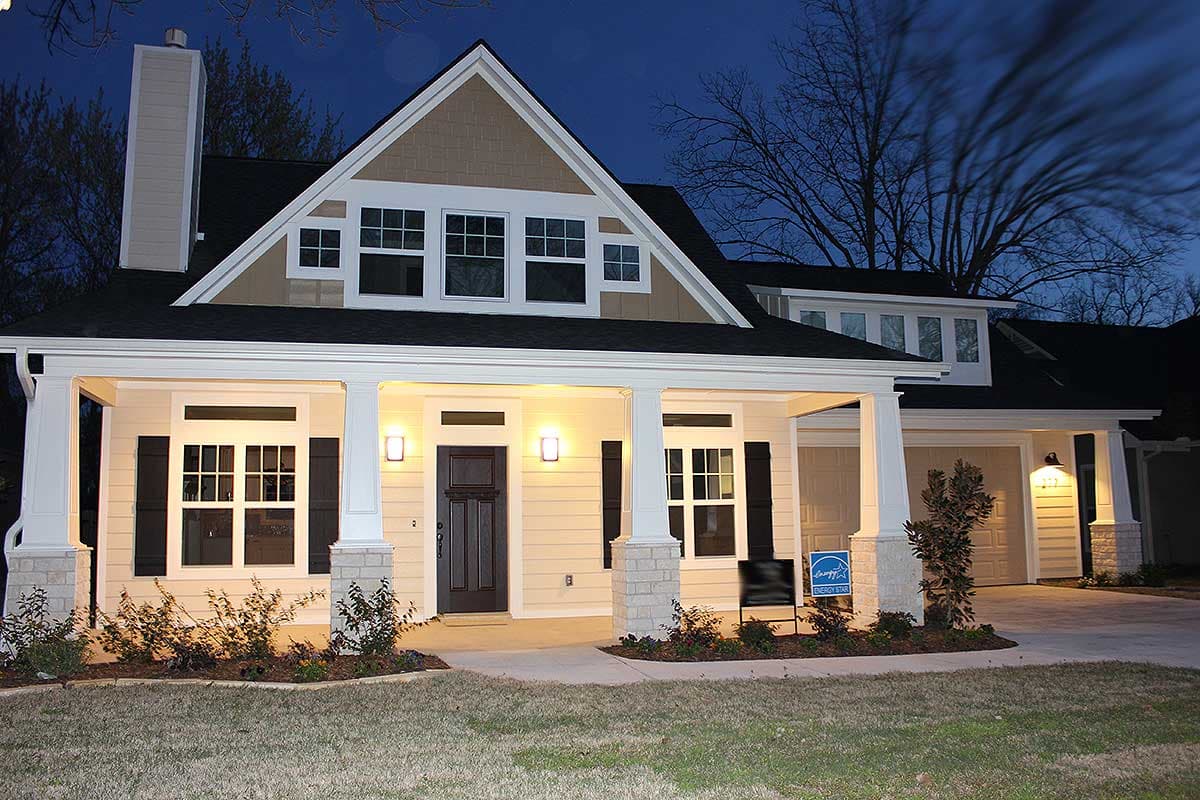 Craftsman house plan exterior with a prominent front porch, gables, dormers, and a two-car garage.