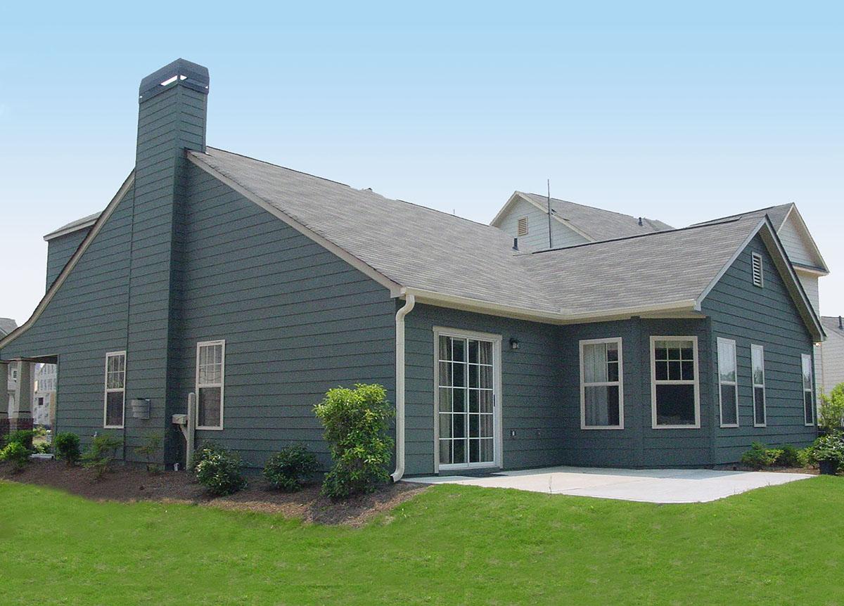 House plan exterior view of a two-story home with a prominent brick chimney, gabled roof, and sliding patio doors.