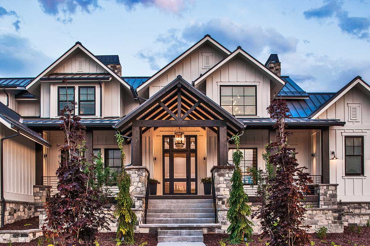 Modern Farmhouse house plan exterior with a prominent gable roof, stone accents, and a dark wood entrance porch.