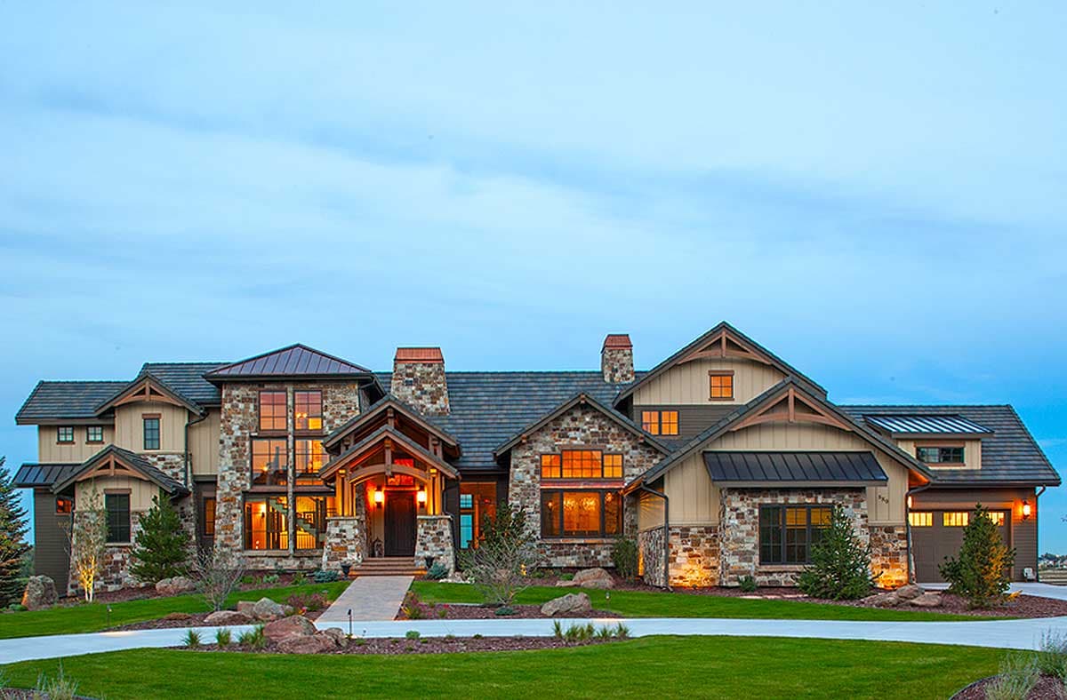 House plan exterior. Craftsman style with stone facade, multiple gables, and covered entry porch with timber framing details.