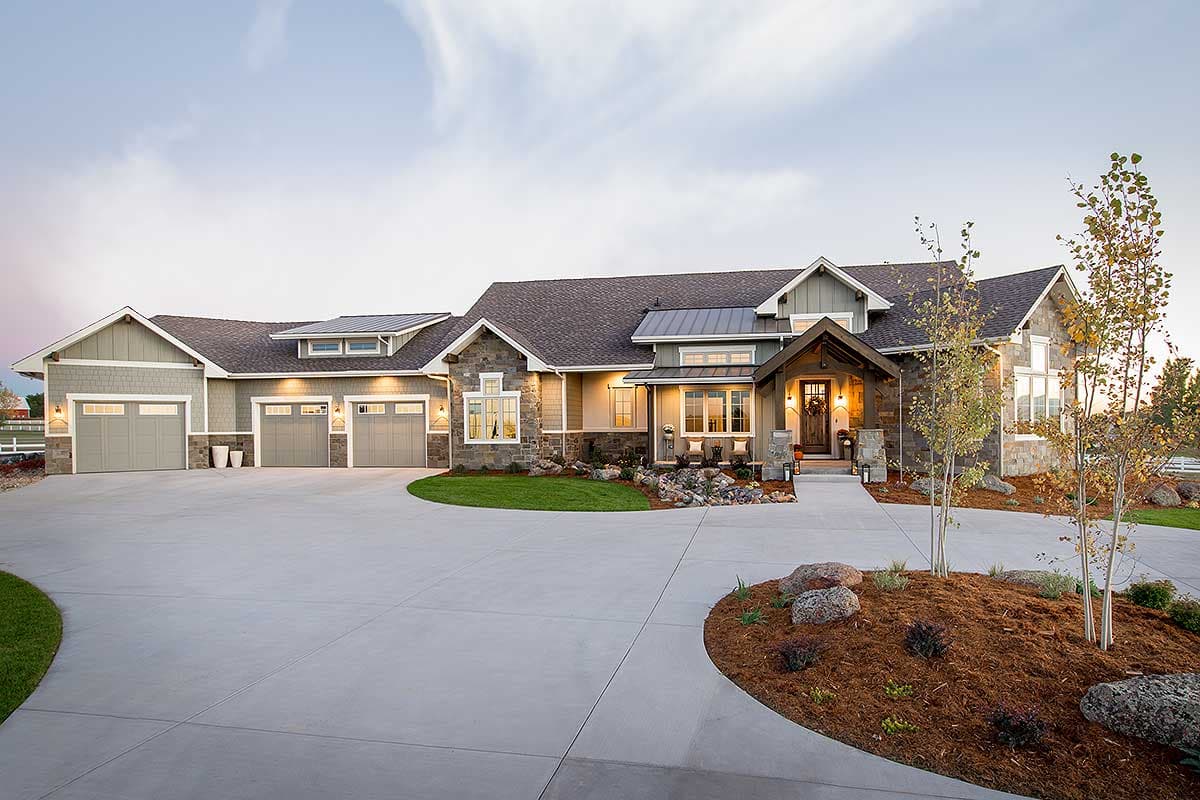 House plan exterior. Two-story home with a Craftsman style, featuring a covered entry porch, multiple gables, and a three-car garage.