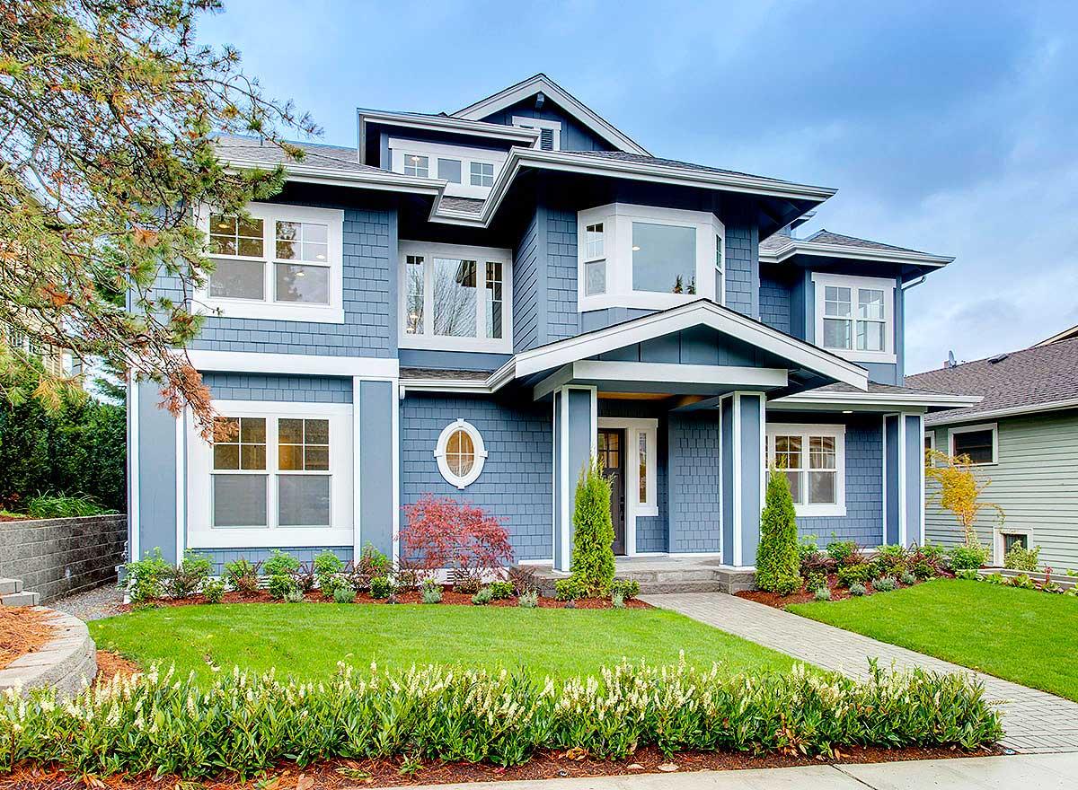 Craftsman-style house plan exterior, two stories, with prominent gables, bay windows, and covered entryway.