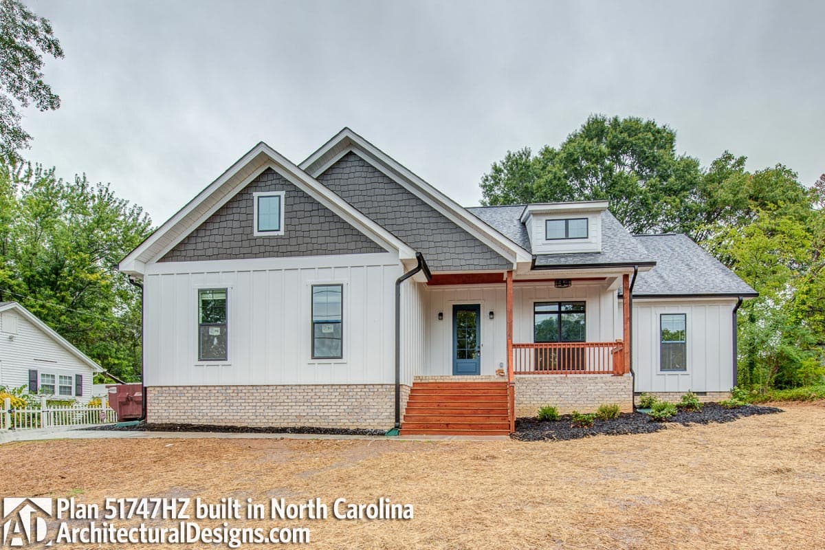 Modern Farmhouse house plan exterior with board and batten siding, brick base, gabled dormer, and covered porch.