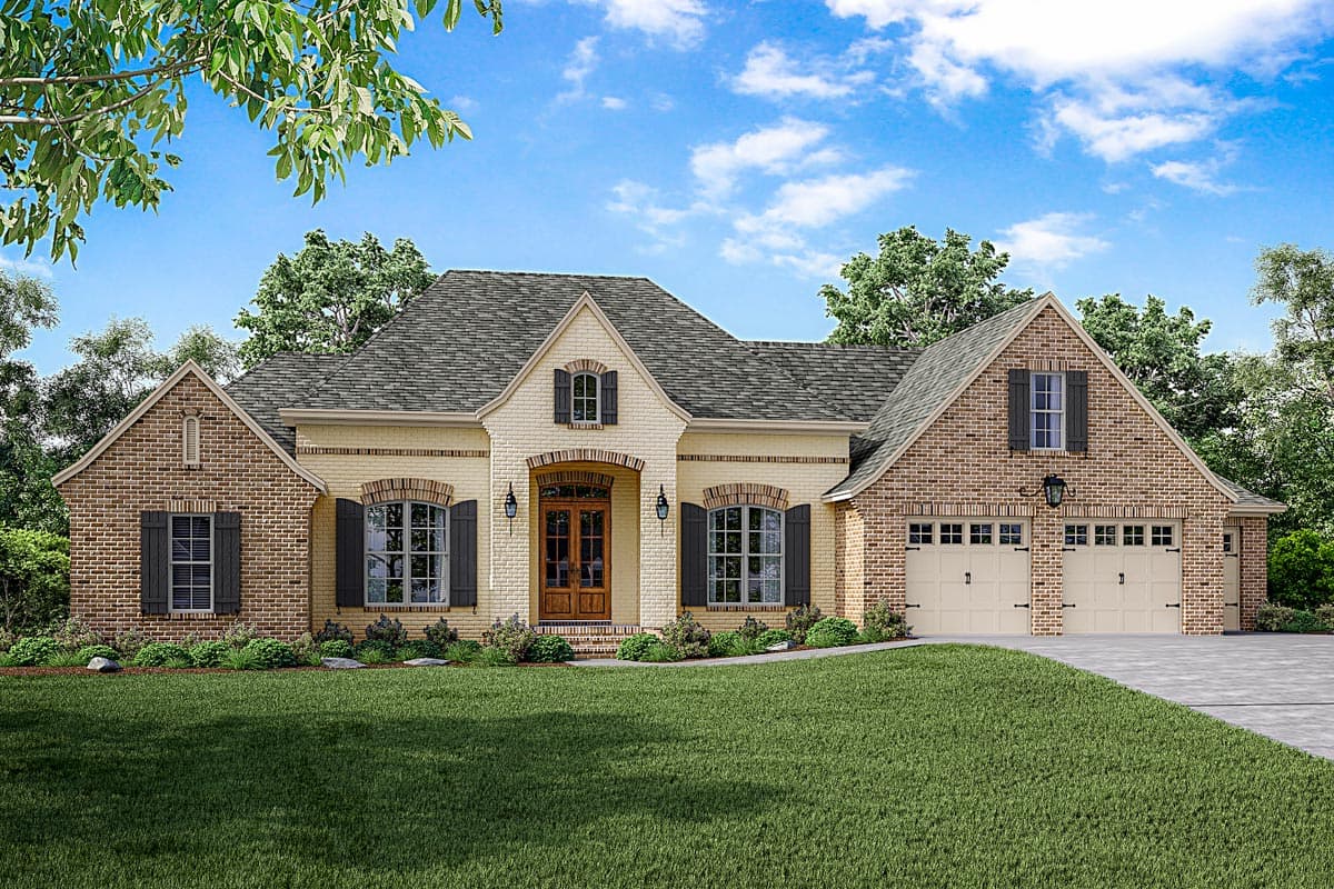 House plan exterior: One-story home with brick and light yellow siding, arched entry, gabled dormer, and a three-car garage.