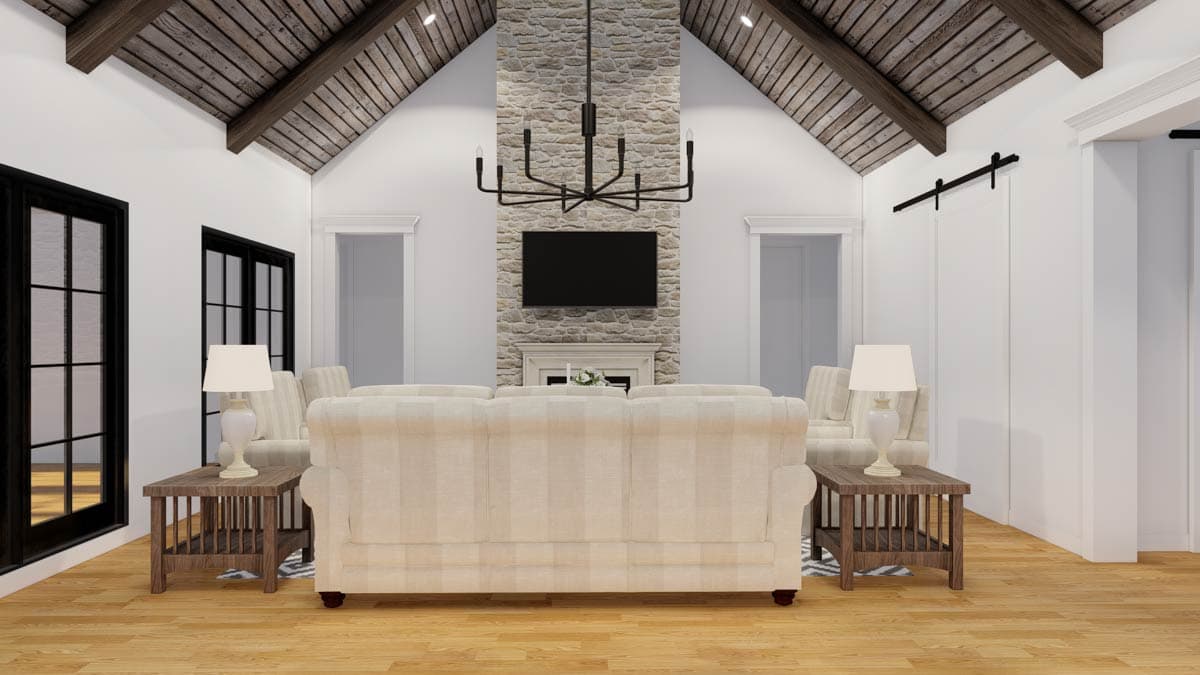 Great room with vaulted, wood-paneled ceiling, stone fireplace, television, and large windows.