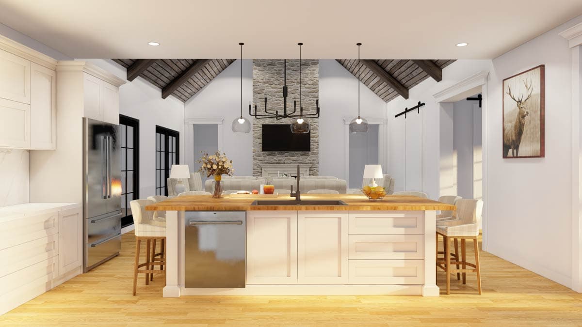 Kitchen and great room with vaulted beamed ceiling, stone fireplace, island with sink, and stainless steel refrigerator.