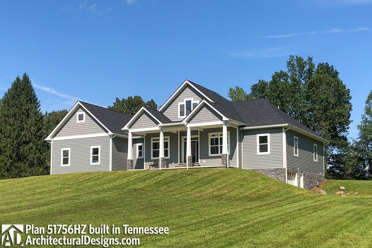 House plan exterior: Single-story Modern Farmhouse with a covered front porch, gables, dormers, and side-entry garage.
