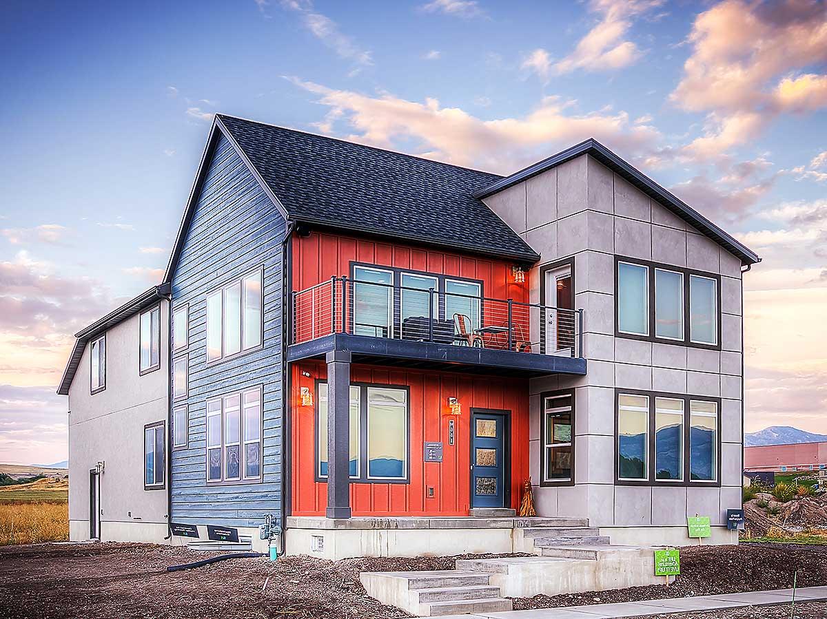 Modern house plan exterior with two stories, mixed siding, and a second-story balcony.