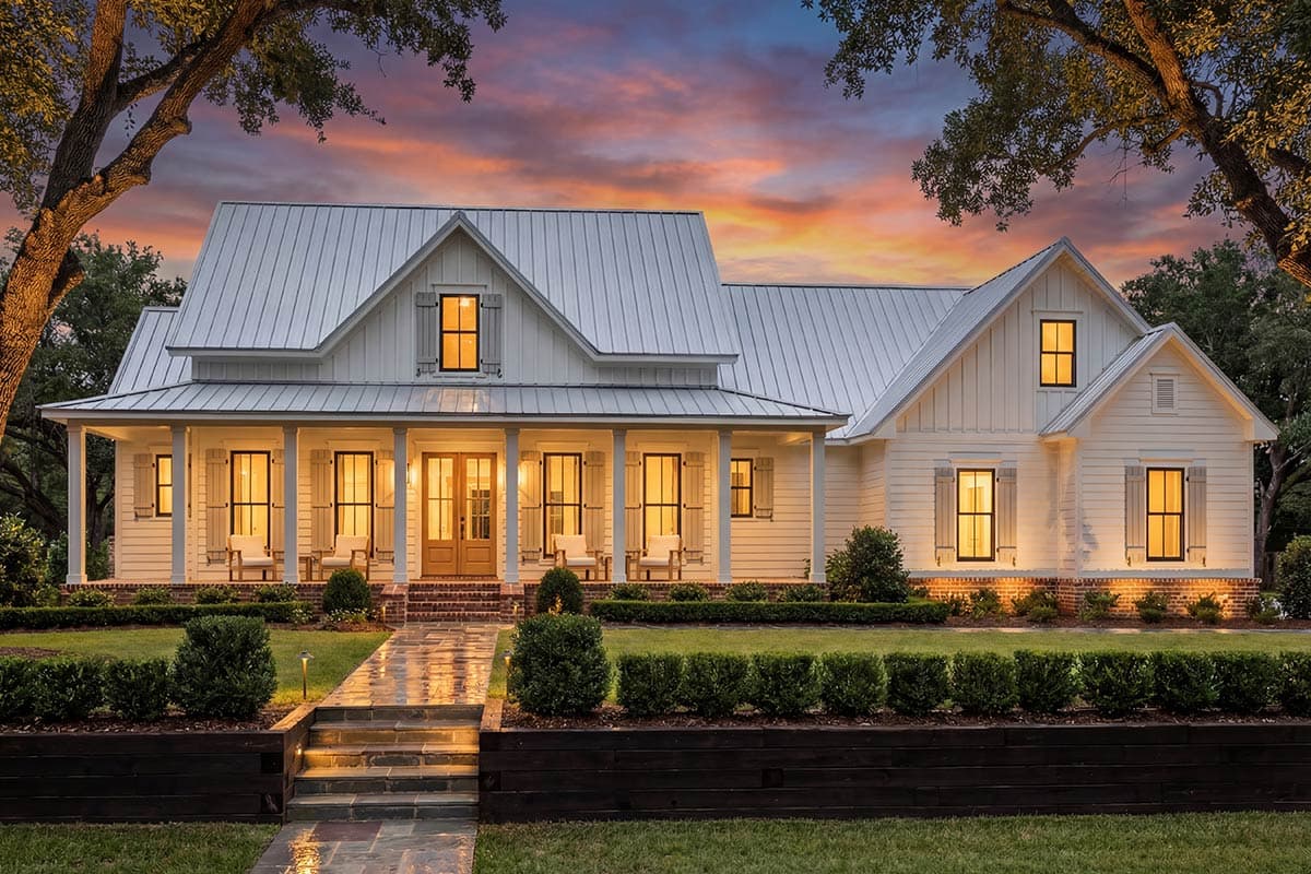 Modern Farmhouse house plan exterior with a wraparound porch, metal roof, and gabled dormers.