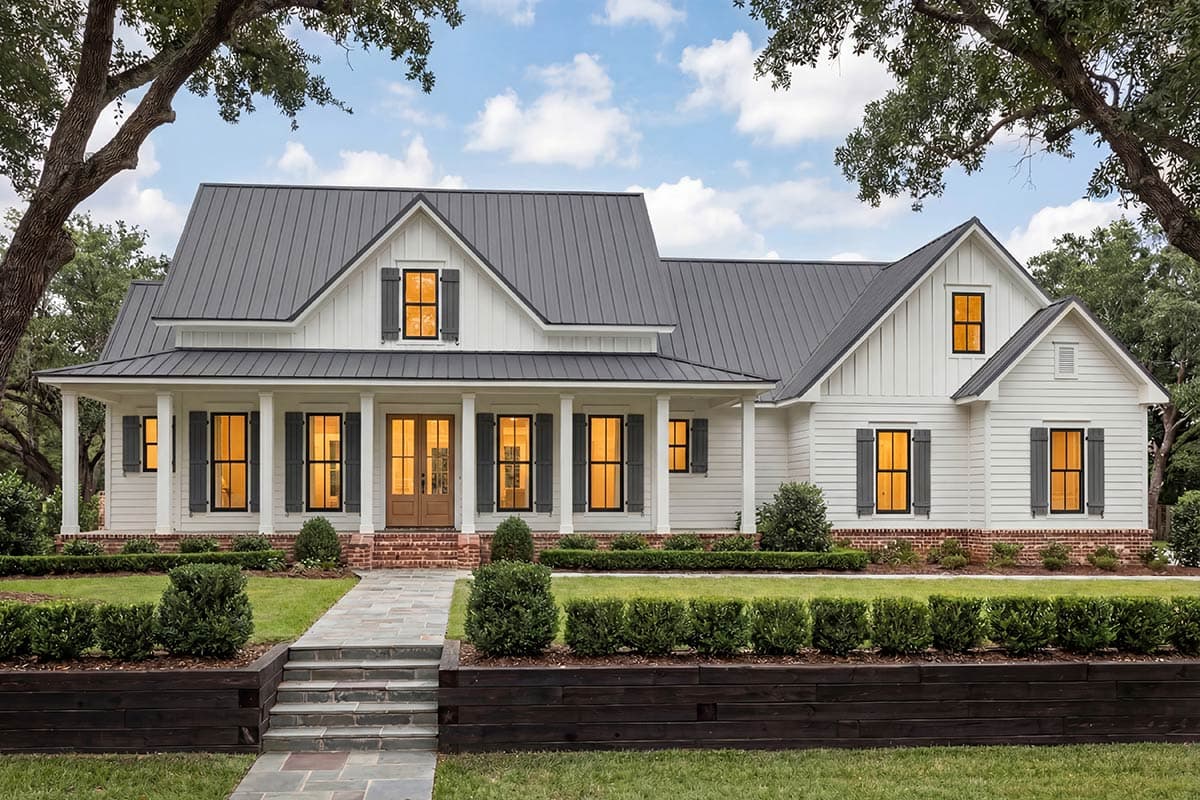 Modern Farmhouse house plan exterior with a metal gable roof, wraparound porch, board and batten siding, and brick foundation.