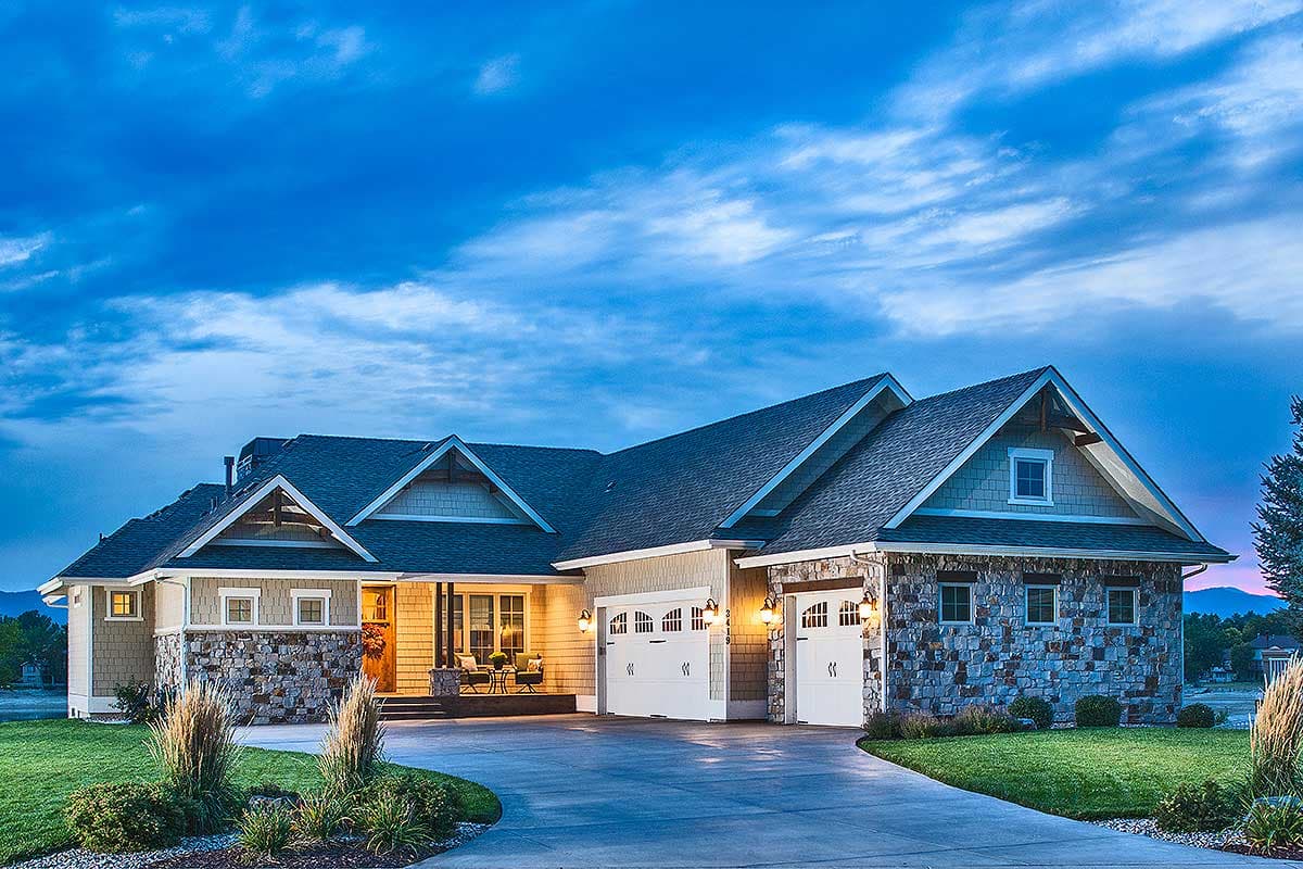 Craftsman house plan exterior with stone accents, multiple gables, and a two-car garage. Features a covered porch and dormers.