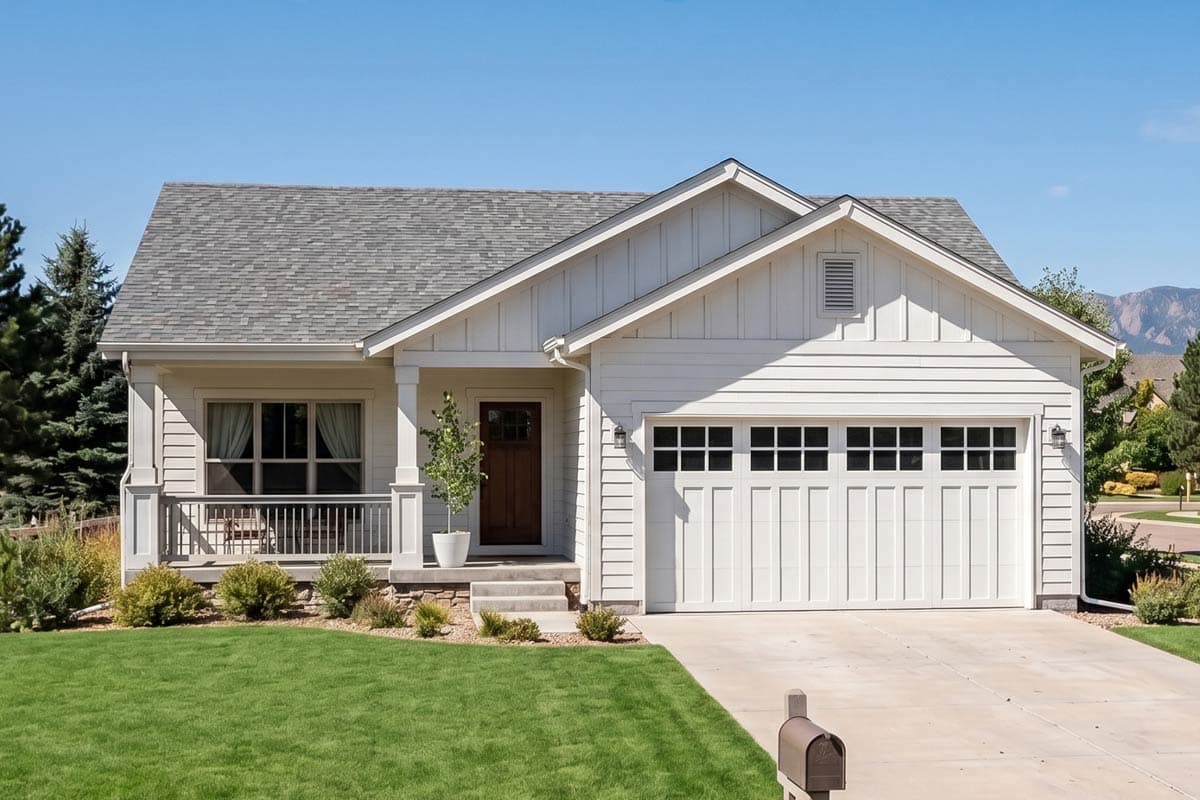 House plan exterior. Craftsman style, single-story home with a gabled roof and a front porch. Features an attached garage and horizontal siding.