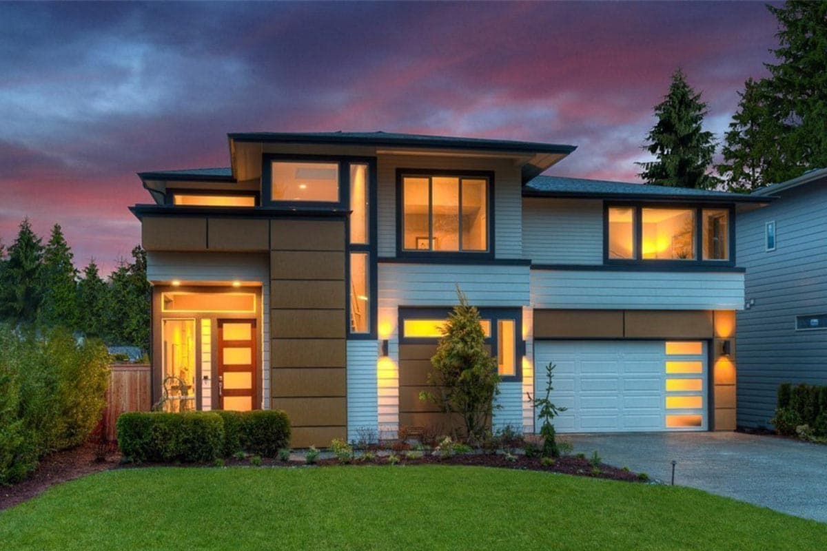 House plan exterior featuring a two-story Modern style with flat roof, vertical siding, an attached garage, and large windows. Includes landscaping.