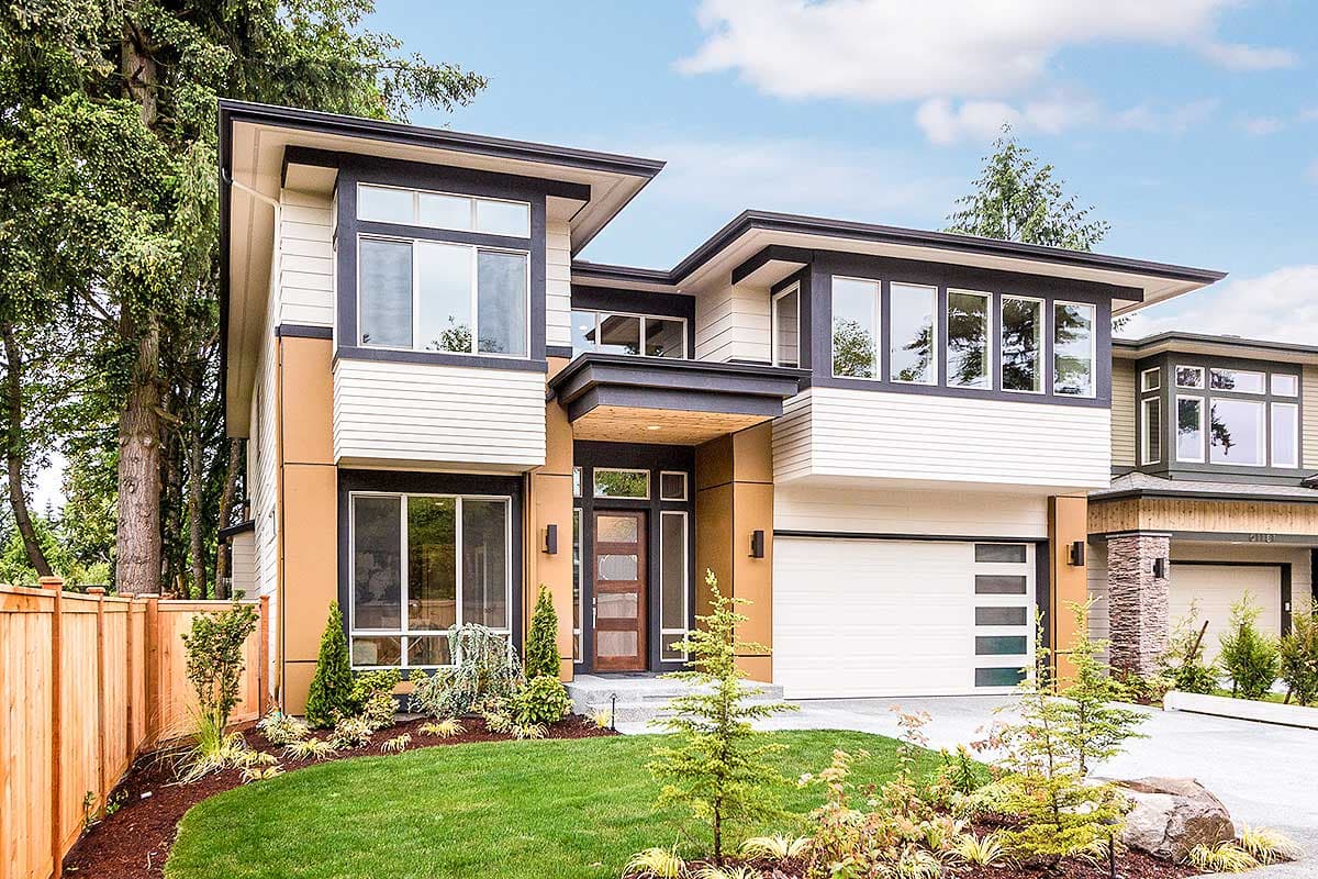 Modern house plan exterior with cantilevered upper stories, flat rooflines, large windows, and a wood-paneled entryway.