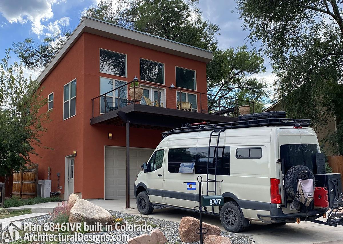 Modern two-story house plan exterior with stucco finish, upper balcony, and attached garage.