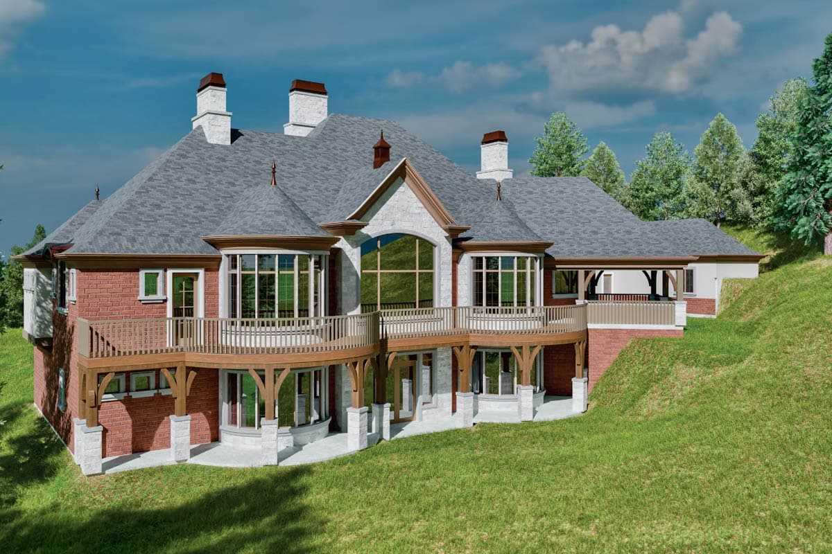 House plan exterior view shows a multi-story home with brick facade, multiple gables, bay windows, and a wraparound deck.