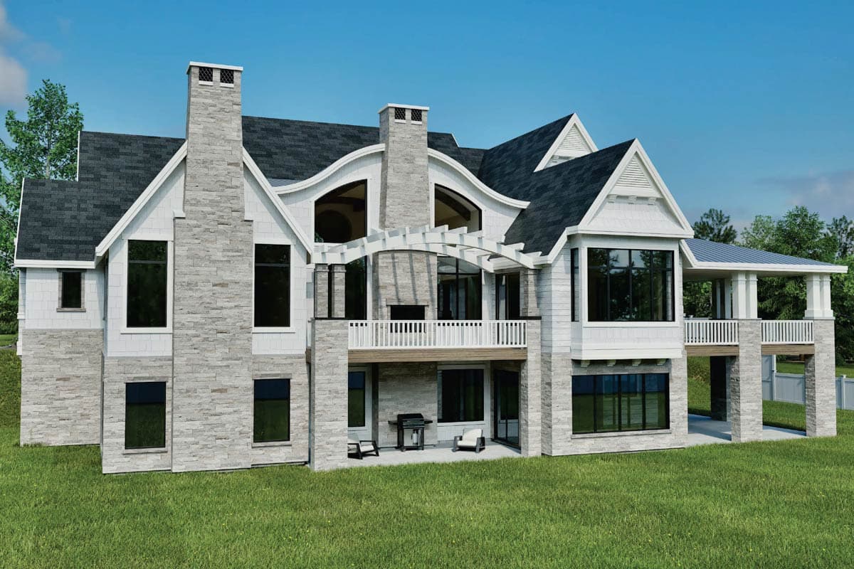 House plan exterior: multi-story home with stone and shingle facade, prominent chimneys, gables, and covered balconies.