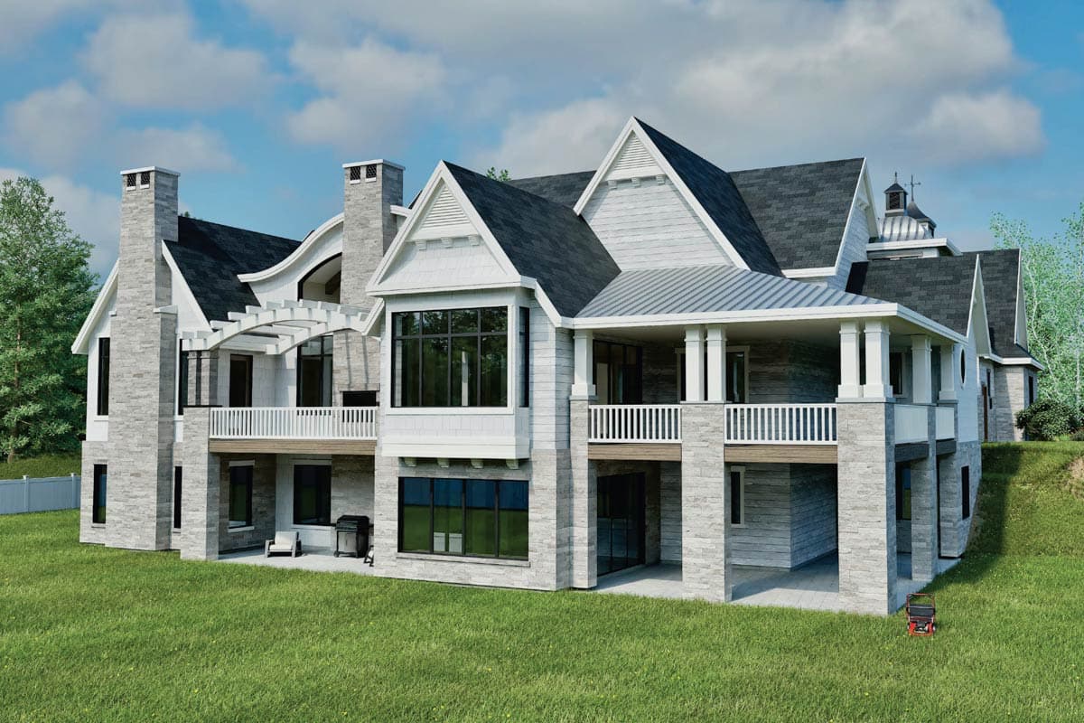 House plan exterior: Large home with stone and shingle siding, multiple gables, covered porches, and prominent chimneys.