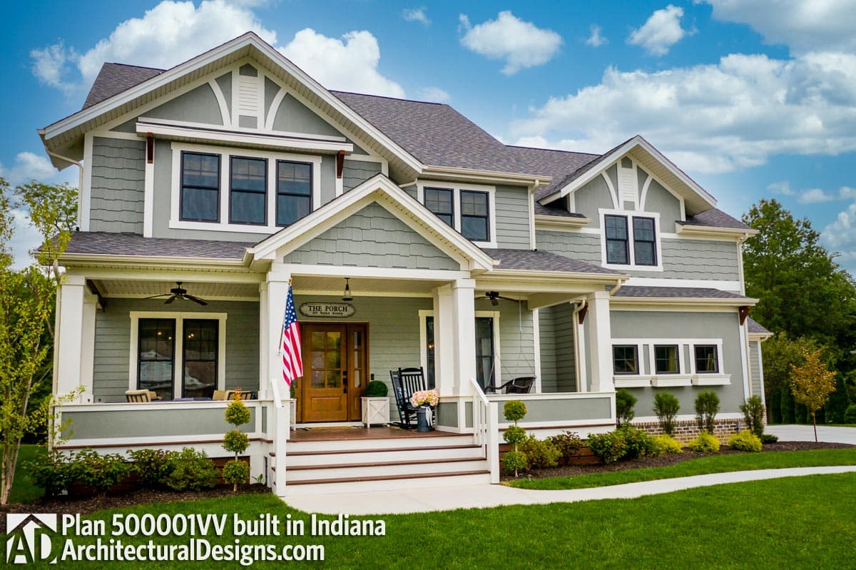 House plan exterior of a two-story modern farmhouse with a wraparound porch, multiple gables, and decorative trim.