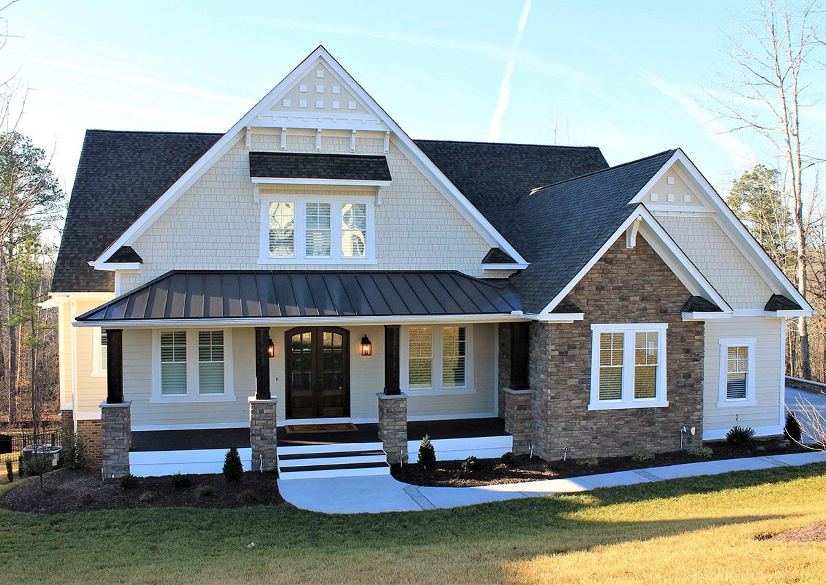 House plan exterior with Craftsman style, two stories, front porch, gables, and stone accents on facade.