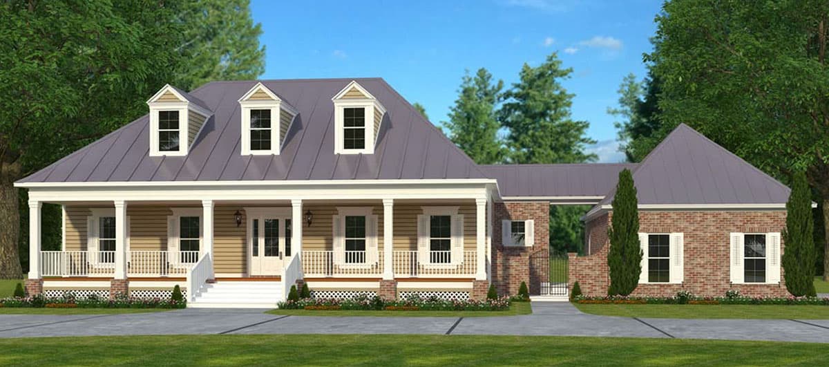 House plan exterior. Two-story house in a traditional style with a front porch, dormers, and a brick accent. Detached garage with similar roof.