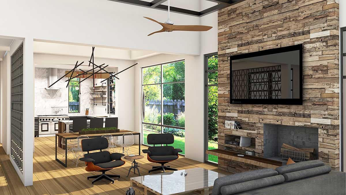 Open concept living area with modern furniture, stone fireplace, large windows, and a view of the kitchen.