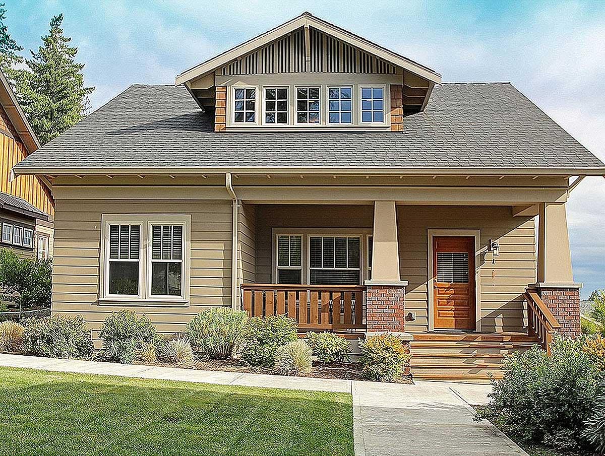 House plan exterior. Craftsman style, one story home with front porch, gabled roof, dormer, and exposed rafter tails.