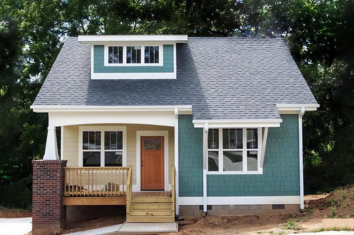 House plan exterior. Craftsman style, one story home with dormer, front porch, and exposed rafter tails.