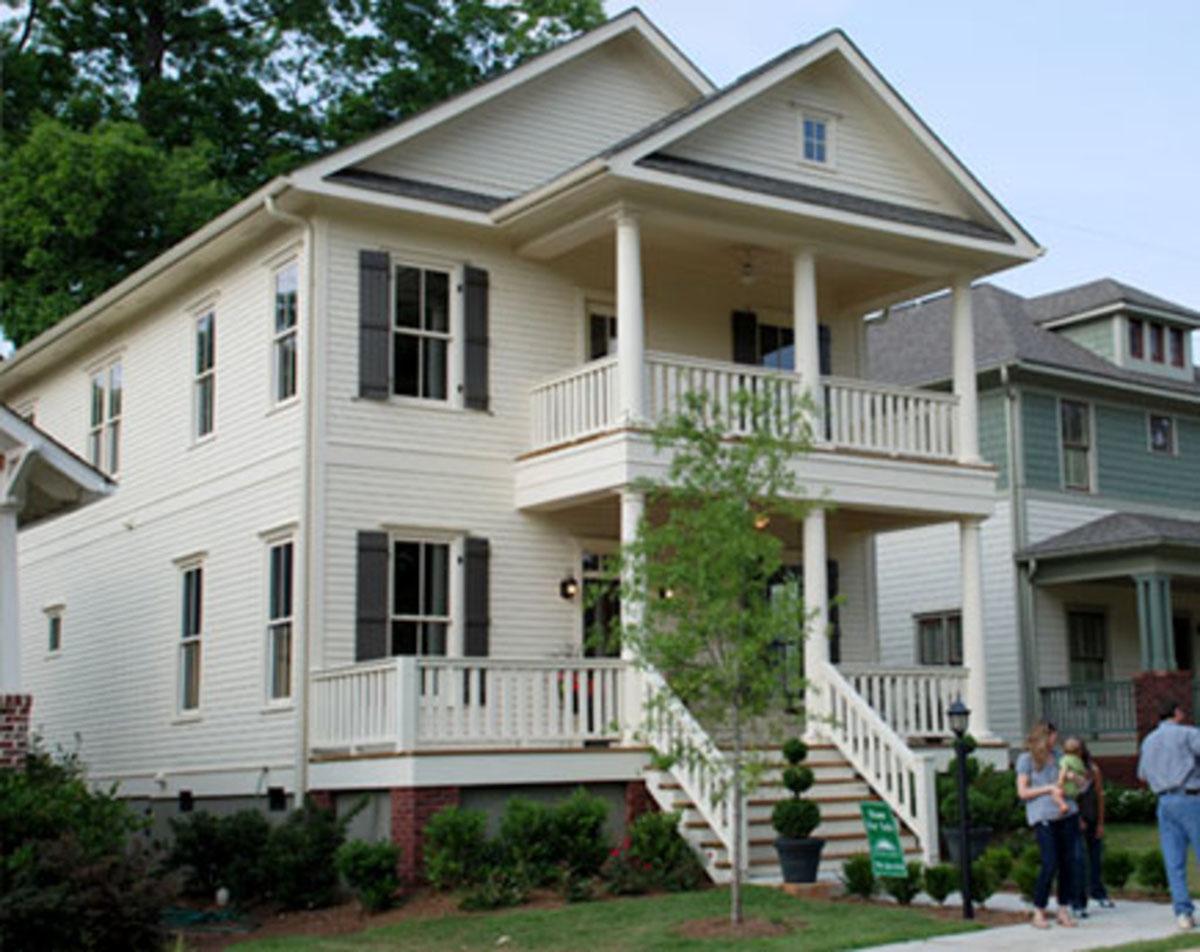 Two-story house plan exterior with front porches, gables, and lap siding.
