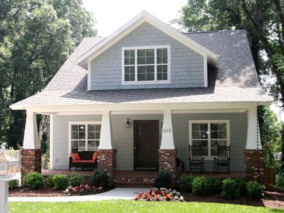 House plan exterior of a two-story Modern Farmhouse with a covered front porch supported by brick and white columns.