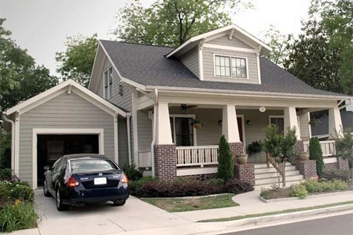 Craftsman house plan exterior with gabled dormer, covered front porch with brick columns, and attached garage.
