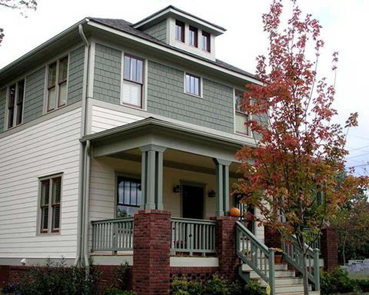House plan exterior of a two-story home with a covered porch, shingle siding, and dormers.