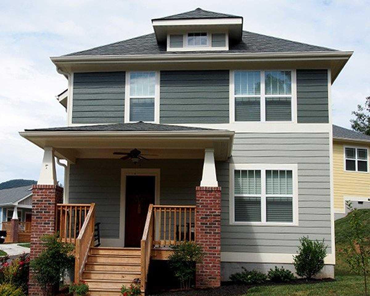 Craftsman style house plan exterior, two stories, covered front porch with columns, dormer window, and multi-pane windows.